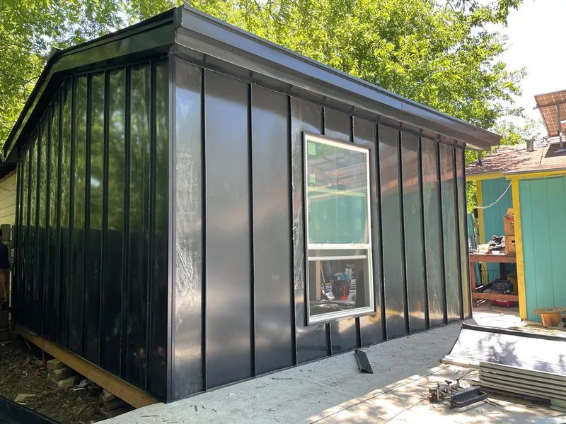 Black standing seam metal wall panels for Roof Inspection in Forney