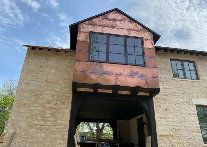Copper metal panel facade on a stone building for Skylight Installation in Forney
