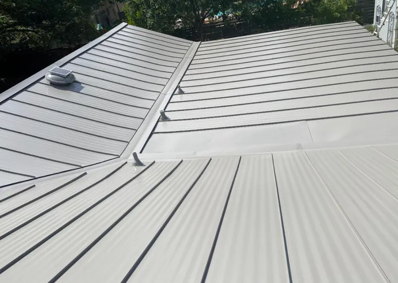 Solar attic fan installed on a metal roof for Roof Ventilation in Forney